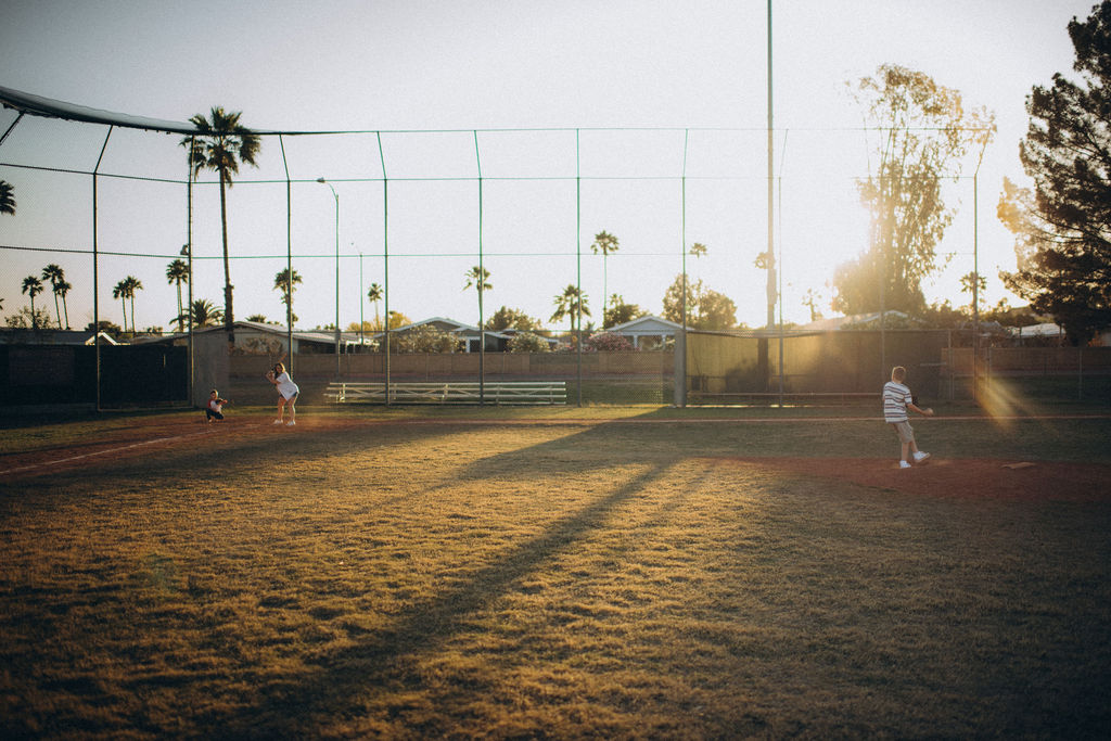 family playing baseball in a scottsdale field for their storytelling photo session