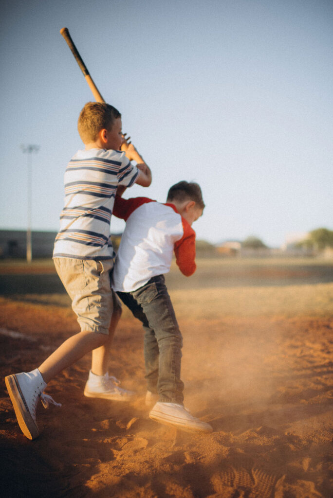 boys racing to the bat for their storytelling photo session