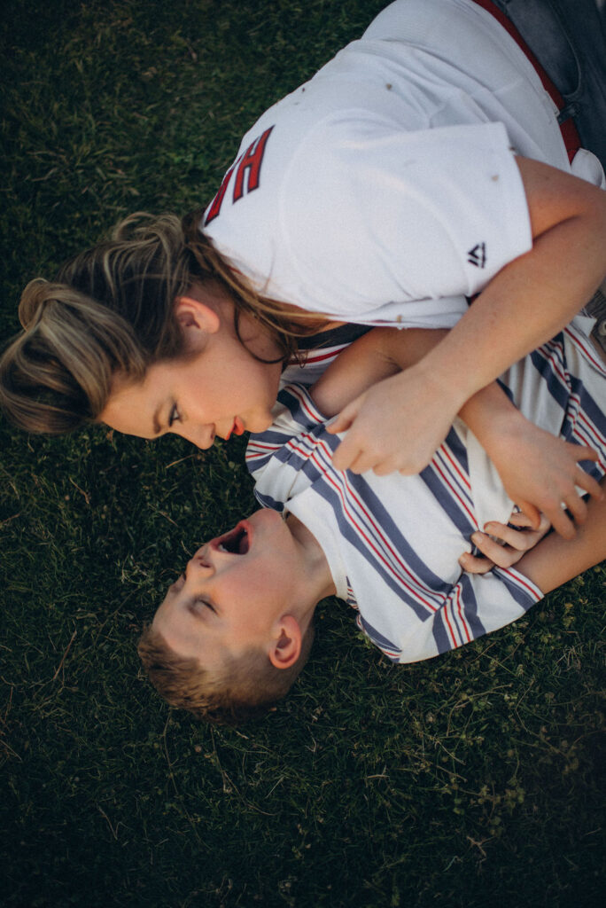 mom and son on the grass laughing