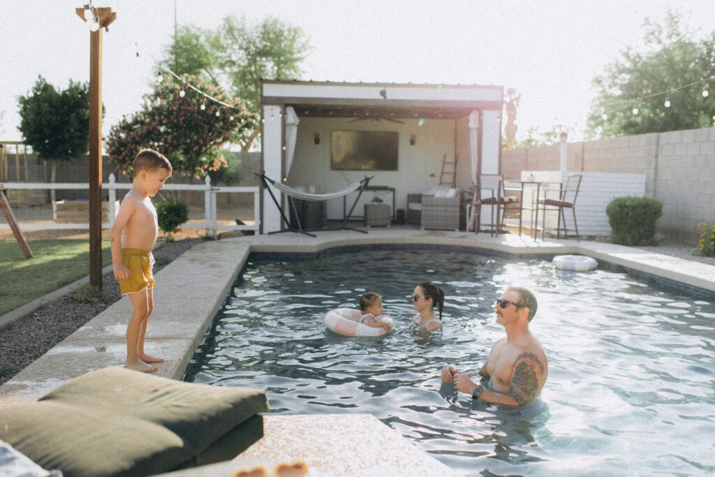 family playing in the pool in arizona