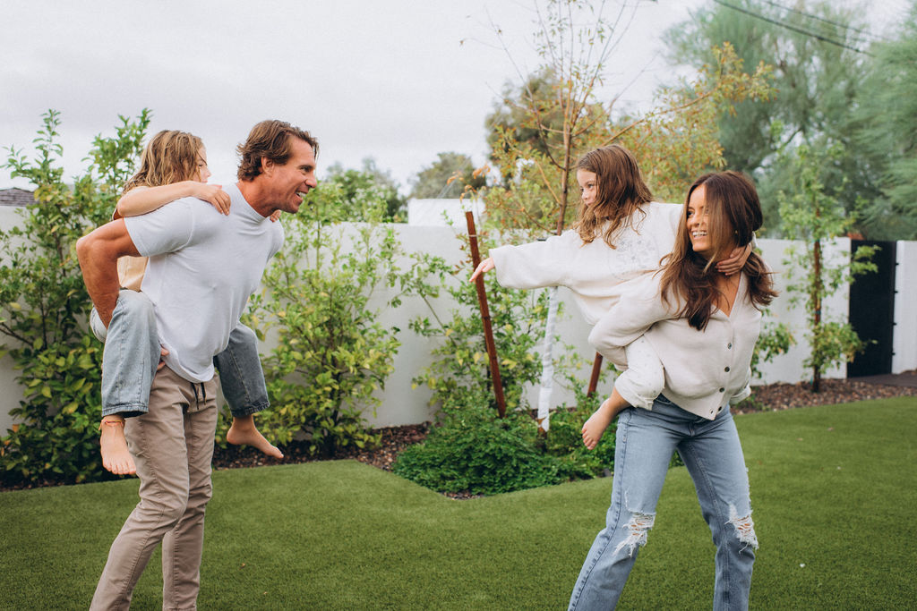 candid scottsdale family playing in the backyard with their kids